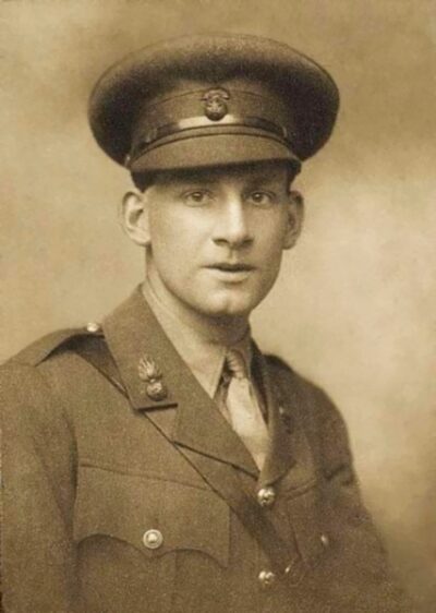 An old photo of a young man in military dress.